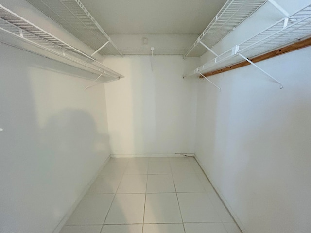 spacious closet with tile floors