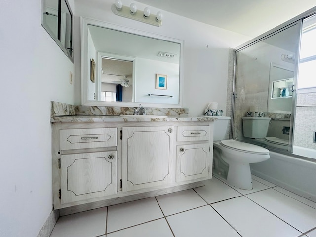 full bathroom with tile flooring, a healthy amount of sunlight, toilet, and vanity