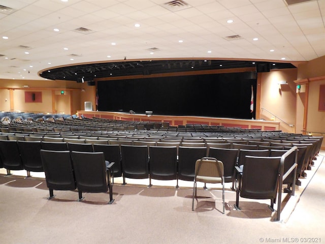 carpeted cinema featuring a paneled ceiling