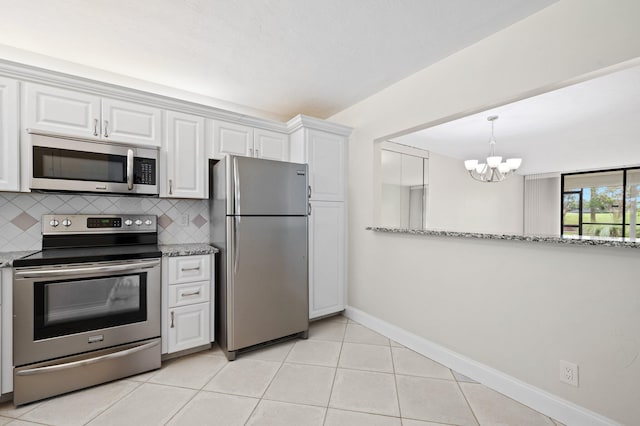 kitchen featuring tasteful backsplash, stainless steel appliances, and white cabinets