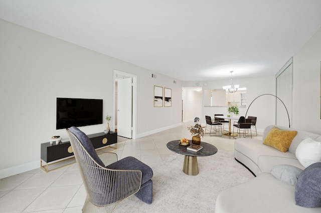 tiled living room with a notable chandelier