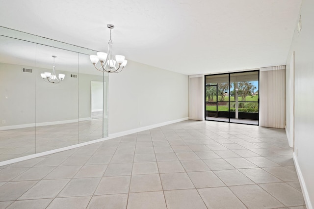 tiled empty room with floor to ceiling windows and a notable chandelier