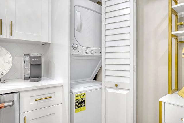 clothes washing area featuring stacked washer / dryer