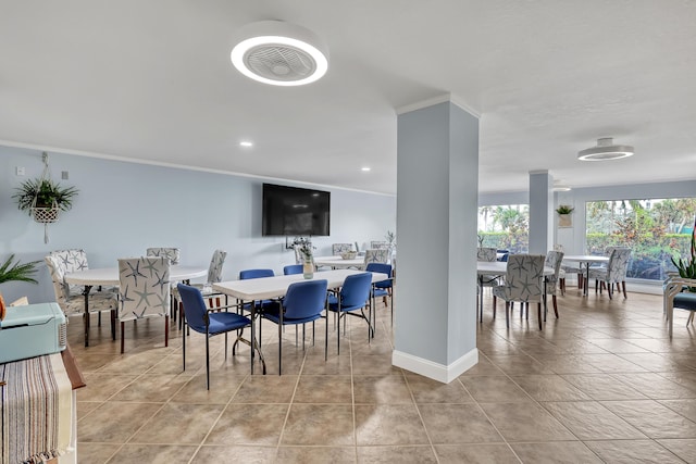 dining room featuring light tile patterned floors and ornamental molding