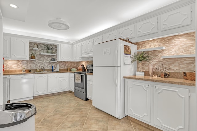 kitchen featuring white cabinets, light tile patterned flooring, and white appliances