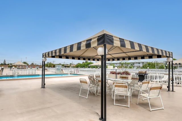 view of patio / terrace featuring a grill and a community pool