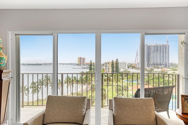 sunroom featuring a water view and plenty of natural light