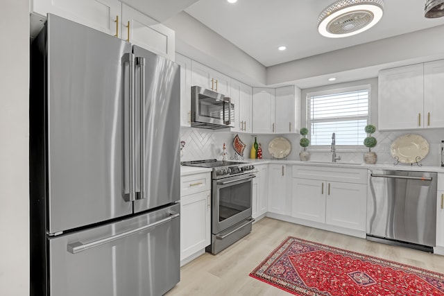 kitchen featuring white cabinets, sink, and stainless steel appliances