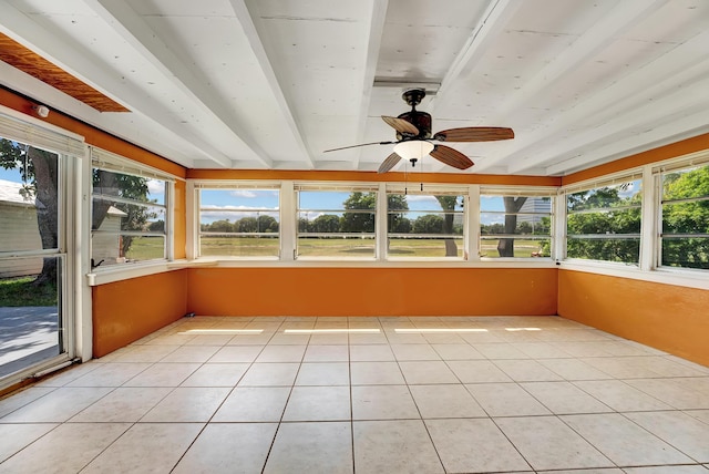 unfurnished sunroom featuring ceiling fan