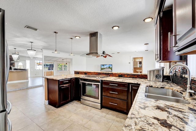 kitchen featuring sink, decorative light fixtures, island range hood, kitchen peninsula, and stainless steel appliances