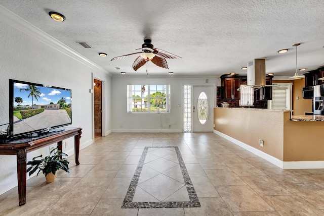 interior space featuring a textured ceiling, ceiling fan, and ornamental molding