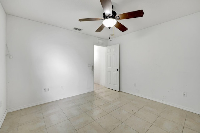 tiled spare room featuring ceiling fan