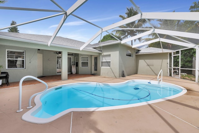 view of pool with a patio and glass enclosure