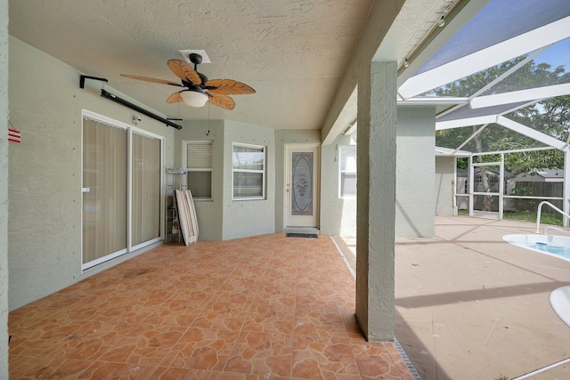 view of patio / terrace with ceiling fan and glass enclosure