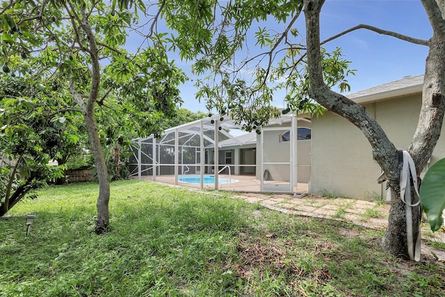 view of yard with glass enclosure