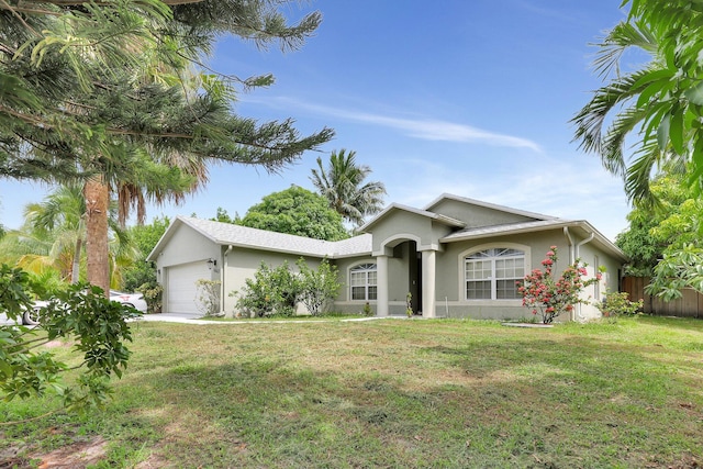 single story home featuring a garage and a front lawn