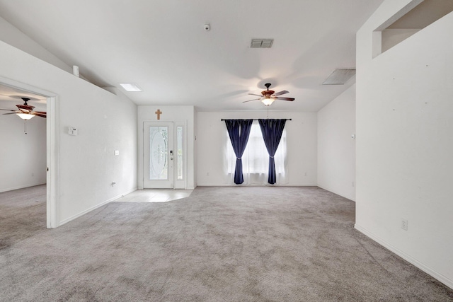 unfurnished room featuring light carpet, lofted ceiling, and ceiling fan