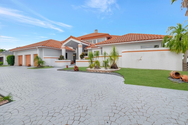 mediterranean / spanish-style home with a front yard