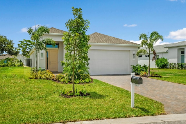 view of front facade featuring a garage and a front lawn