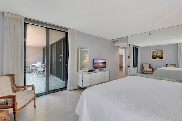 bedroom featuring light hardwood / wood-style floors and access to outside