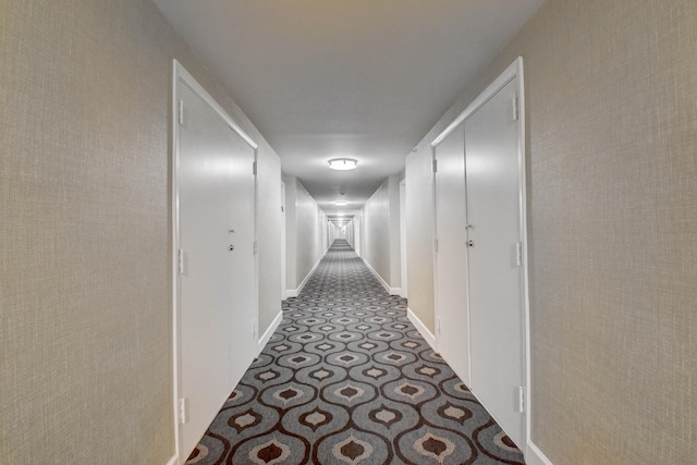 hallway featuring dark tile floors