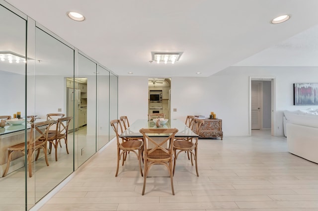 dining space with light hardwood / wood-style flooring