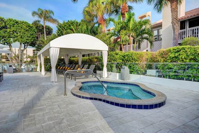 view of pool featuring a patio area and a hot tub