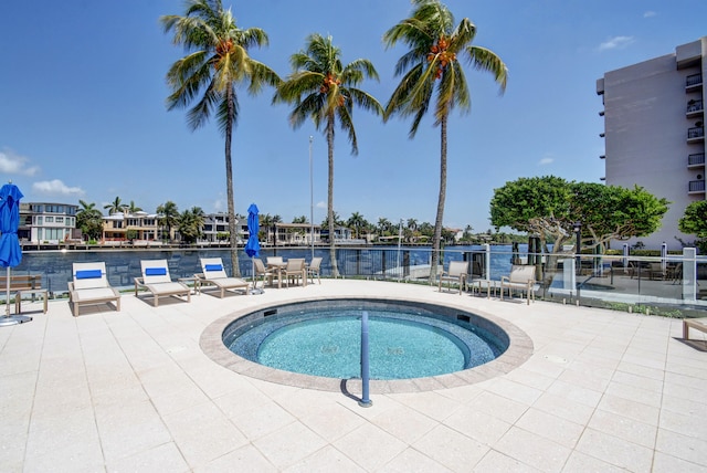 view of pool with a patio and a hot tub