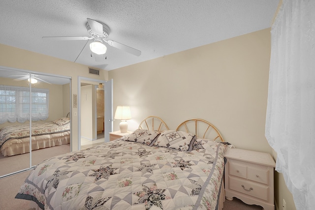 bedroom featuring a textured ceiling, a closet, ceiling fan, and carpet floors