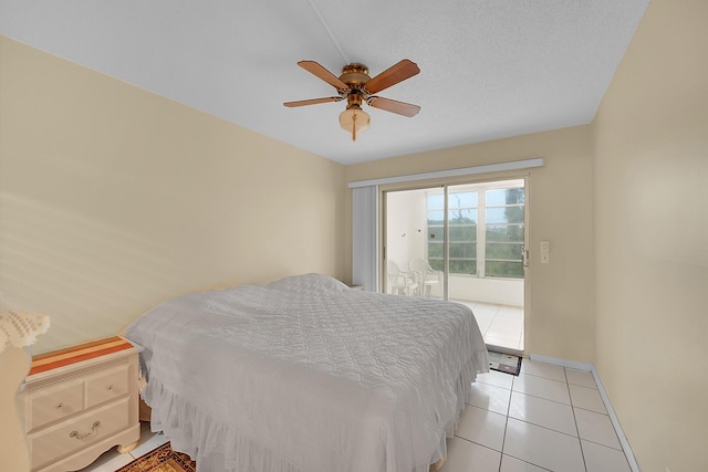 tiled bedroom with access to exterior, a textured ceiling, and ceiling fan