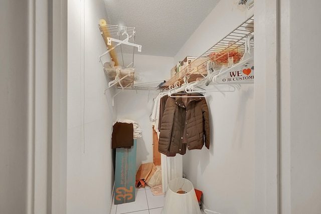 spacious closet featuring tile patterned flooring