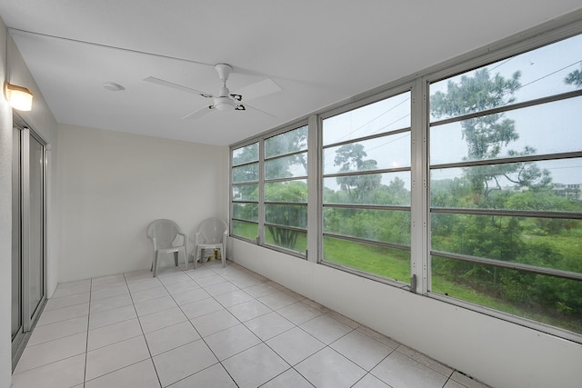 unfurnished sunroom featuring ceiling fan