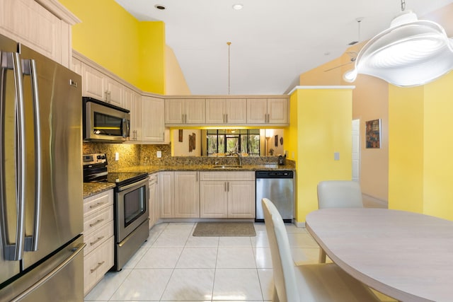 kitchen featuring appliances with stainless steel finishes, light tile floors, kitchen peninsula, tasteful backsplash, and light brown cabinetry