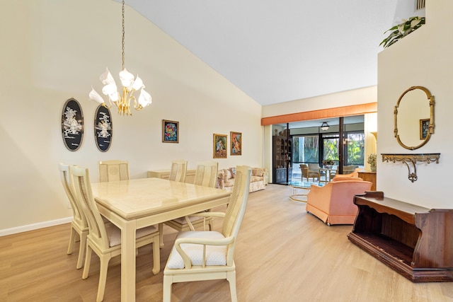 7825 Lexington Club Blvd Unit B, Delray Beach, FL 33446 - dining space with high vaulted ceiling, light wood-style floors, baseboards, and an inviting chandelier