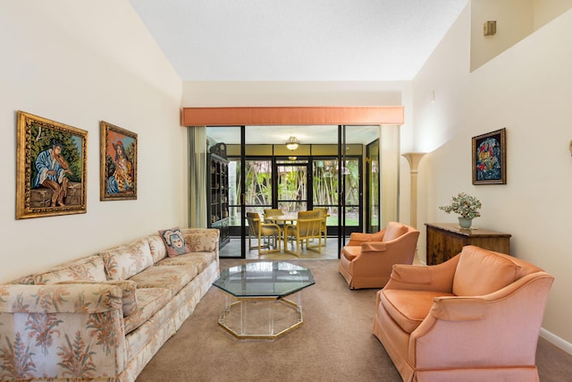 living room with high vaulted ceiling and carpet flooring