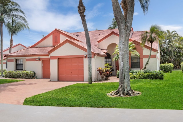 view of front of home with a garage and a front lawn