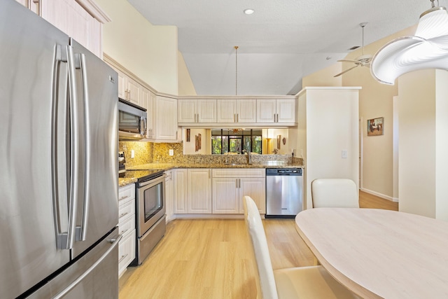 7825 Lexington Club Blvd Unit B, Delray Beach, FL 33446 - kitchen featuring ceiling fan, light wood-type flooring, light stone counters, a sink, and stainless steel appliances