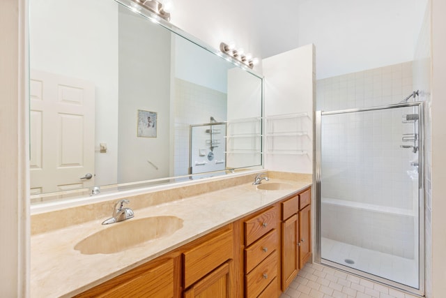 bathroom with double vanity, an enclosed shower, and tile floors