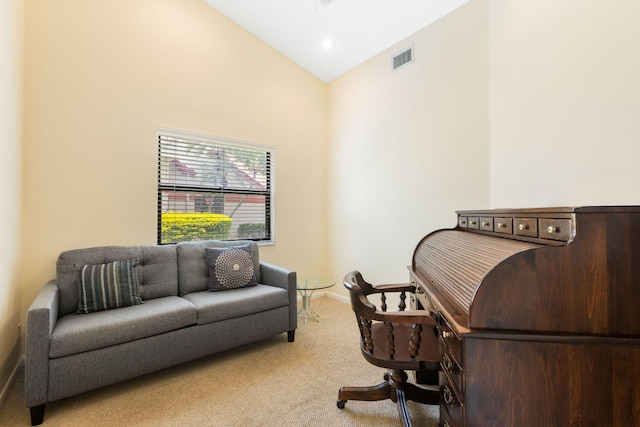 interior space featuring high vaulted ceiling and carpet flooring