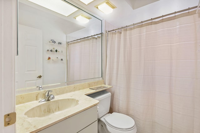 bathroom featuring toilet and vanity