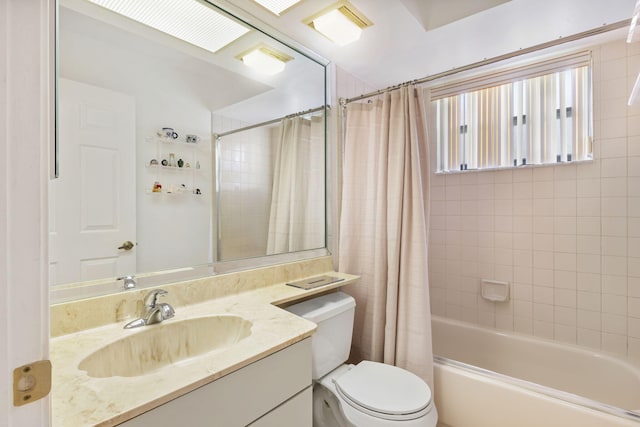 full bathroom featuring shower / bathtub combination with curtain, vanity, and toilet