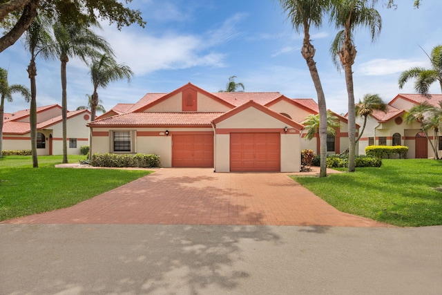 7825 Lexington Club Blvd Unit B, Delray Beach, FL 33446 - view of front of home with a tiled roof, stucco siding, decorative driveway, a front yard, and an attached garage