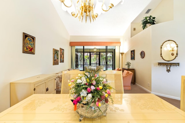 carpeted dining area with high vaulted ceiling and an inviting chandelier