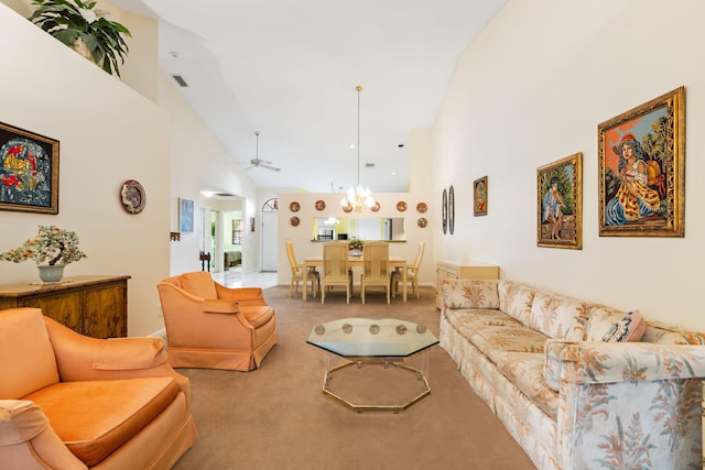 living room with high vaulted ceiling, carpet, and ceiling fan with notable chandelier