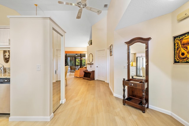 7825 Lexington Club Blvd Unit B, Delray Beach, FL 33446 - hall with light wood-style flooring, baseboards, visible vents, and lofted ceiling