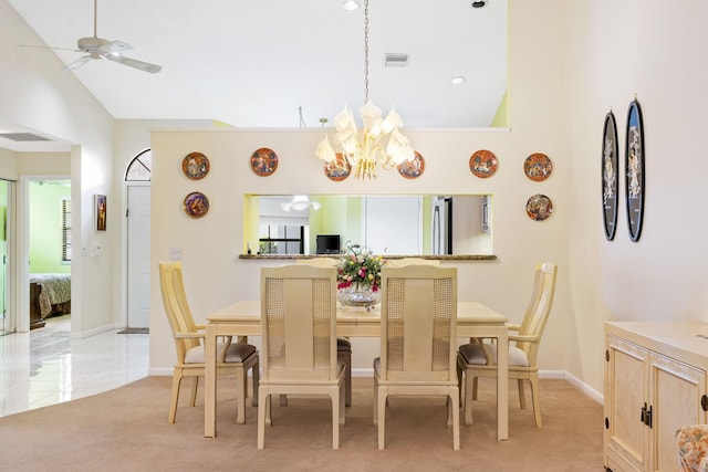 carpeted dining room featuring lofted ceiling and ceiling fan with notable chandelier