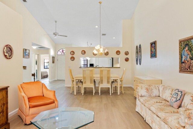 7825 Lexington Club Blvd Unit B, Delray Beach, FL 33446 - living room featuring high vaulted ceiling, light wood-type flooring, baseboards, and ceiling fan with notable chandelier