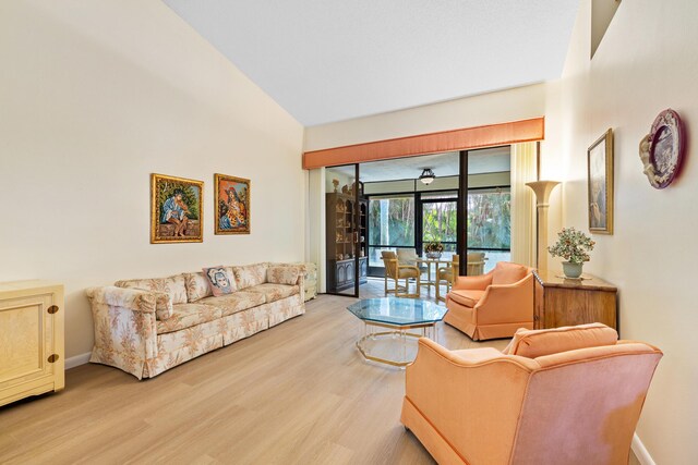 7825 Lexington Club Blvd Unit B, Delray Beach, FL 33446 - living area featuring a high ceiling, light wood finished floors, and baseboards