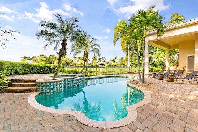 view of swimming pool with an in ground hot tub and a patio