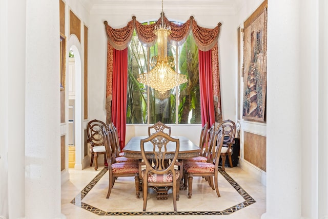 dining area with ornamental molding and a chandelier